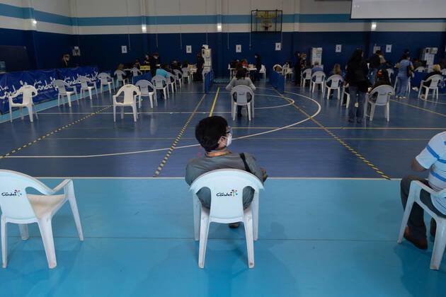 March 22, 2021, Santiago, Metropolitana, Chile: A man waits to receive the dose of the Sinovac or Pfizer vaccine, in a municipal stadium transformed into a vaccination center against covid in Santiago, Chile. Santiago Chile - ZUMAb332 20210322_zip_b332_006 Copyright: xMatiasxBasualdox