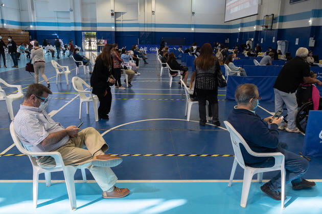 March 22, 2021, Santiago, Metropolitana, Chile: Two men wait in line to receive the dose of the Sinovac or Pfizer vaccine, in a municipal stadium transformed into a vaccination center against covid in Santiago de Chile. Santiago Chile - ZUMAb332 20210322_zip_b332_009 Copyright: xMatiasxBasualdox