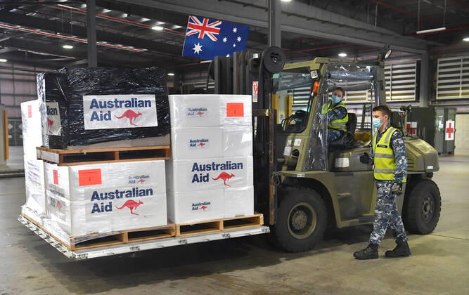 AUSMAT VACCINE PNG COVID19 RESPONSE, Royal Australian Air Force personal are seen preparing COVID-19 vaccines and humanitarian supplies for loading onto a C-17A Globemaster at RAAF Base Amberley, west of Brisbane, Tuesday, March 23, 2021. Australia are sending 8,000 doses of its COVID-19 vaccine supply to Papua New Guinea who have more than 1,400 active cases of COVID-19 and the Australian government are asking AstraZeneca and European authorities to divert another 1 million doses to Papua New Guinea. ( NO ARCHIVING, EDITORIAL USE ONLY, NO USE IN BOOKS WITHOUT CONSENT BRISBANE QLD AUSTRALIA  Copyright: xDARRENxENGLANDx 20210323001529483913