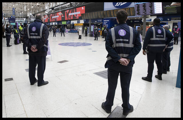 . 23 03 2021. London, United Kingdom. Transport police, staff and passengers at Waterloo Train Station in London , observe a minutes silence to mark the National Day of Reflection on the anniversary of the first Covid 19 lockdown in the United Kingdom.  xStephenxLockx xi-Imagesx IIM-22074-0016