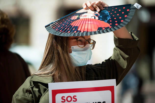 March 23, 2021, Malaga, Spain: A protester wearing a mask holds a placard at Plaza de la Constitucion square during the demonstration..Employees from S.O.S Souvenirs association in Malaga, who work in tourists stores of souvenirs, demand the Spanish government sector survival facing fall incomes due to coronavirus pandemic. Many tourist stores and shops have had to close after restrictions of tourist sector and arrivals of tourists in Spain. Malaga Spain - ZUMAs197 20210323_zaa_s197_003 Copyright: xJesusxMeridax
