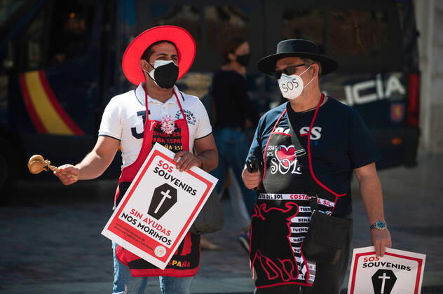 March 23, 2021, Malaga, Spain: Protesters wearing masks hold placards at Plaza de la Constitucion square during the demonstration..Employees from S.O.S Souvenirs association in Malaga, who work in tourists stores of souvenirs, demand the Spanish government sector survival facing fall incomes due to coronavirus pandemic. Many tourist stores and shops have had to close after restrictions of tourist sector and arrivals of tourists in Spain. Malaga Spain - ZUMAs197 20210323_zaa_s197_014 Copyright: xJesusxMeridax