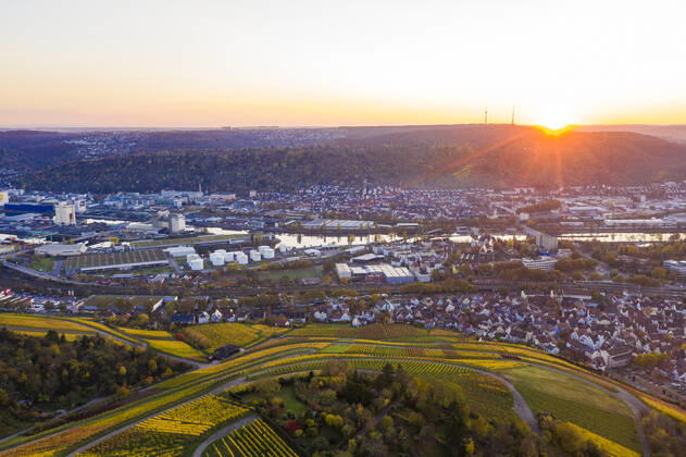 Germany, Baden Wurttemberg, Stuttgart, Aerial view of city and vineyards at sunset in autumn WDF06554