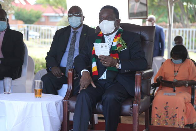 (210324) -- VICTORIA FALLS (ZIMBABWE), March 24, 2021 -- Zimbabwean President Emmerson Mnangagwa (Front) shows his COVID-19 vaccination card in Victoria Falls, Zimbabwe, on March 24, 2021. Mnangagwa got his first shot of China s Sinovac COVID-19 vaccine in Victoria Falls on Wednesday. (Photo by Xinhua) ZIMBABWE-VICTORIA FALLS-PRESIDENT-COVID-19 VACCINE ChenxYaqin