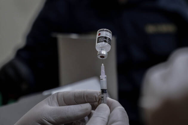 March 25, 2021, Depok, Jawa Barat, Indonesia: A vial with a dose of Sinovac COVID-19 vaccine seen with a syringe during a mass vaccination drive for the public sector workers at Geospatial Information Agency Office in Bogor..Indonesia is currently in the second phase of mass covid-19 vaccination. In this second phase, the Indonesian government targets 38.5 million people, including 16.9 million workers in public sectors and 21.6 million elderly citizens, as well as workers in hospitality, transportation, tourism sectors and mass media workers. Depok Indonesia - ZUMAs197 20210325_zaa_s197_085 Copyright: xRisaxKrisadhix