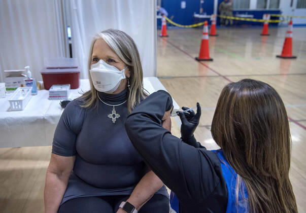 March 26, 2021, USA: New Mexico Governor Michelle Lujan Grisham receives her Pfizer COVID-19 vaccine from Deanne Tapia, a RN with the New Mexico Public Health Office in Santa Fe, during a vaccination event held in the gym at Desert Sage Academy in Santa Fe, Friday March 26, 2021. USA - ZUMAab1_ 20210326_zaf_ab1_005 Copyright: xEddiexMoorex