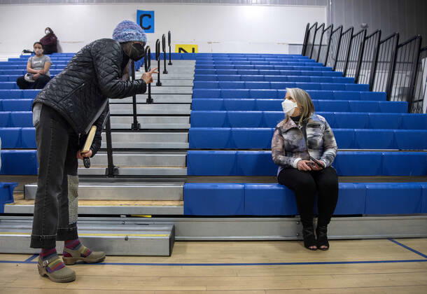 March 26, 2021, USA: Kimber Seymour, left, a school nurse for Santa Fe Public Schools, thanks New Mexico Governor Michelle Lujan Grisham for the way she has handled the COVID-19 pandemic in New Mexico. They were waiting after receiving their Pfizer COVID-19 vaccine during a vaccination event held in the gym at Desert Sage Academy in Santa Fe, Friday March 26, 2021. USA - ZUMAab1_ 20210326_zaf_ab1_006 Copyright: xEddiexMoorex