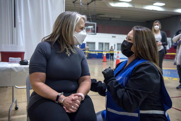 March 26, 2021, USA: New Mexico Governor Michelle Lujan Grisham talks with Deanne Tapia, a RN with the New Mexico Public Health Office in Santa Fe, before receiving her Pfizer COVID-19 vaccine during a vaccination event held in the gym at Desert Sage Academy in Santa Fe, Friday March 26, 2021. USA - ZUMAab1_ 20210326_zaf_ab1_007 Copyright: xEddiexMoorex
