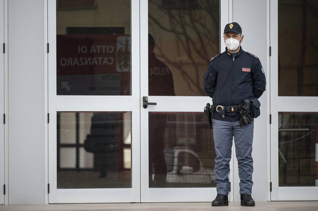 March 26, 2021, Catanzaro, Calabria, Italy: A policeman seen standing in front of the entrance door. Lieutenant general, Francesco Paolo Figliuolo, recently appointed as extraordinary commissioner for the COVID-19 emergency, and Fabrizio Curcio, Head of Department of Civil Protection, visited new vaccination hubs in Calabria. In Catanzaro, in the seacoast district â€oeLidoâ€Â, they visited the new Trade Fair Center selected as potential hub. Sergio Abramo, Mayor of Catanzaro, and Antonino Spirlo¬, and temporary Regional Governor, guided them during the visit. The increasing of vaccination hubs is considered a priority, specially considering the rising number of cases within the region. Catanzaro Italy - ZUMAs197 20210326_zaa_s197_138 Copyright: xValeriaxFerrarox
