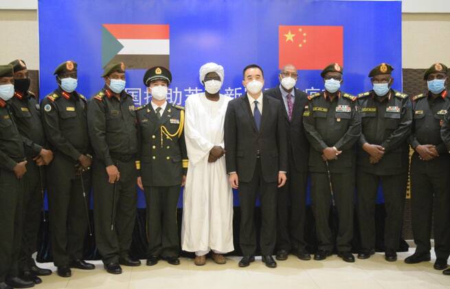 (210327) -- KHARTOUM, March 27, 2021 -- Chinese Ambassador to Sudan Ma Xinmin (5th R) poses for a group photo during a handover ceremony for Chinese vaccines in Khartoum, Sudan, March 26, 2021. A batch of China s Sinopharm COVID-19 vaccines, donated by the Chinese government to Sudan, arrived here on Friday. ) SUDAN-KHARTOUM-CHINESE VACCINE-ARRIVAL MaxYichong 