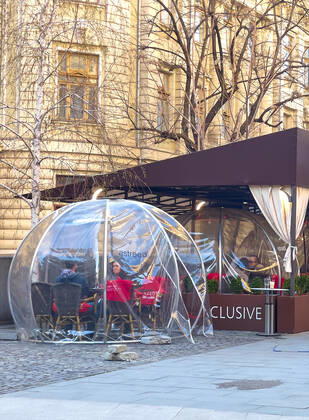 Old town with restaurants and bars with tourists and local people in Bucharest, Romania on March 27, 2021.