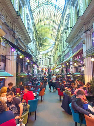 Old town with restaurants and bars with tourists and local people in Bucharest, Romania on March 27, 2021.