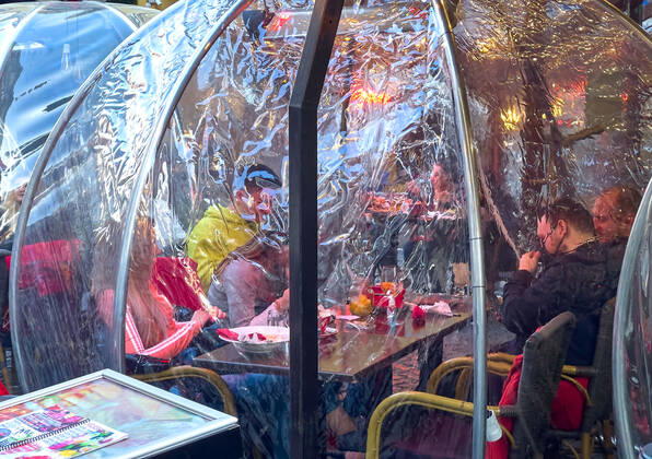 Corona bubbles, protective covers made of plastic in the Old town with restaurants and bars with tourists and local people in Bucharest, Romania on March 27, 2021.