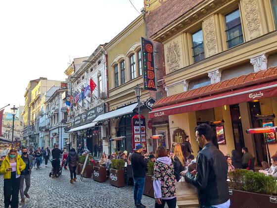 Old town with restaurants and bars with tourists and local people in Bucharest, Romania on March 27, 2021.