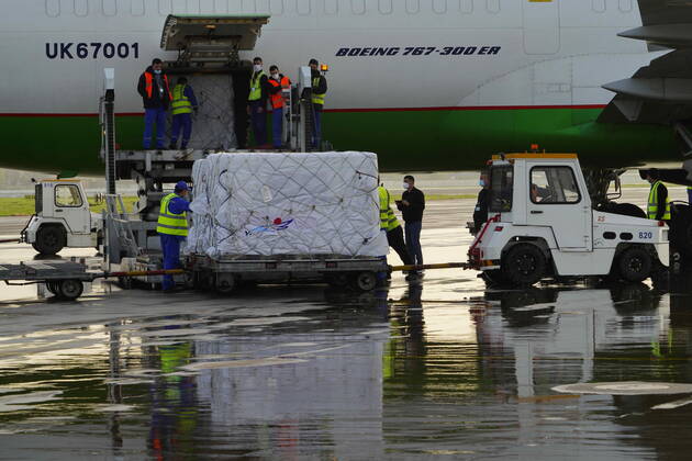 (210327) -- TASHKENT, March 27, 2021 -- Workers unload COVID-19 vaccines at Tashkent International Airport in Tashkent, Uzbekistan, on March 27, 2021. The first batch of Chinese coronavirus vaccines arrived in Uzbekistan Saturday. (Photo by Xinhua) UZBEKISTAN-TASHKENT-CHINA-COVID-19 VACCINES-ARRIVAL ZafarxKhalilov 