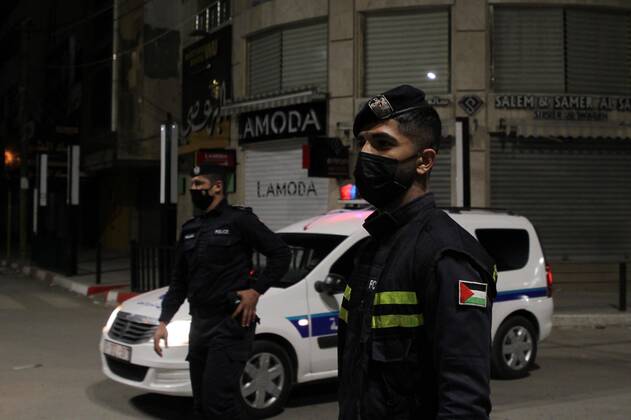 (210328) -- GAZA, March 28, 2021 -- Palestinian police officers stand guard in street in Gaza City, March 27, 2021. The Hamas-run Interior Ministry imposed a full lockdown on Saturday all over the Gaza Strip at night-time from 9:00 PM due to increasing numbers of COVID-19 infection. (Photo by Xinhua) MIDEAST-GAZA CITY-COVID-19 RizekxAbdeljawad 