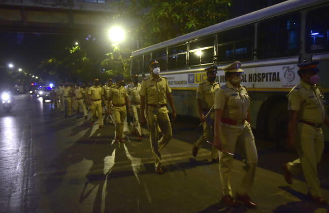 MUMBAI, INDIA - MARCH 28: Mumbai Police personnel held a flag march to raise awareness about night curfew between 8:00 pm to 7:00 am from Sunday, at Bhoiwada, Parel, on March 28, 2021 in Mumbai, India. (Photo by Anshuman Poyrekar Hindustan Times) Covid 19 Night Curfew In Mumbai Tourists Spot Wear Deserted Look