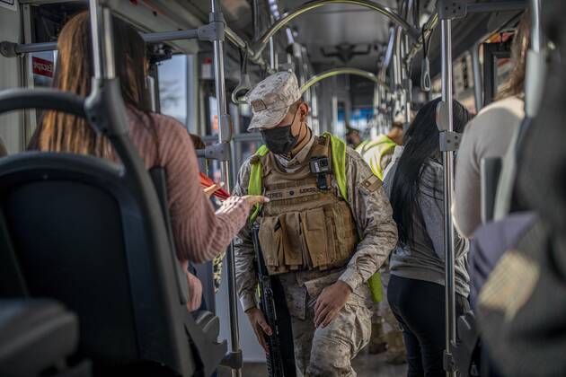 March 29, 2021, Santiago, Chile: A police officer verifies the health permits of the passengers on a public transport bus..Sanitary cords and police controls during the first day of total quarantine in the central area of the country, after the abrupt increase in Covid-19 cases in the Metropolitan region, the country s health authorities decreed a total quarantine for the central area of the country. Although Chile leads the number of vaccinated population, the increase in positive cases puts the stability of the health system at risk again. Santiago Chile - ZUMAs197 20210329_zaa_s197_150 Copyright: xFelipexFigueroax
