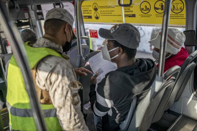 March 29, 2021, Santiago, Chile: A police officer verifies the health permits of the passengers on a public transport bus..Sanitary cords and police controls during the first day of total quarantine in the central area of the country, after the abrupt increase in Covid-19 cases in the Metropolitan region, the country s health authorities decreed a total quarantine for the central area of the country. Although Chile leads the number of vaccinated population, the increase in positive cases puts the stability of the health system at risk again. Santiago Chile - ZUMAs197 20210329_zaa_s197_151 Copyright: xFelipexFigueroax