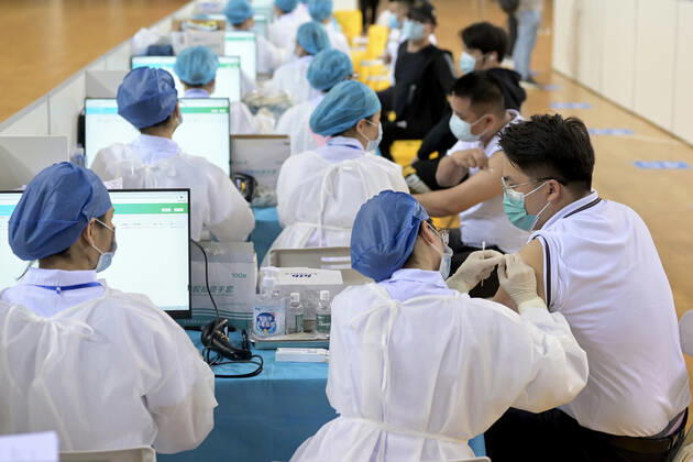 NANNING, CHINA - MARCH 29: Local residents line up to receive the COVID-19 vaccine at Guangxi Sports Center gymnasium on March 29, 2021 in Nanning, Guangxi Zhuang Autonomous Region of China.  Copyright: xVCGx CFP111323471518