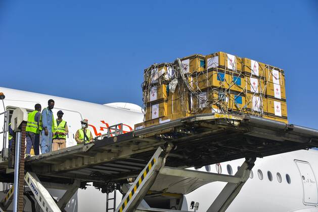 (210330) -- ADDIS ABABA, March 30, 2021 -- Workers unload China s Sinopharm COVID-19 vaccines, donated by the Chinese government to Ethiopia, at the Addis Ababa Bole International Airport in Addis Ababa, Ethiopia, on March 30, 2021. (Photo by Xinhua) ETHIOPIA-ADDIS ABABA-COVID-19-VACCINE-CHINA-DONATION MichaelxTewelde 