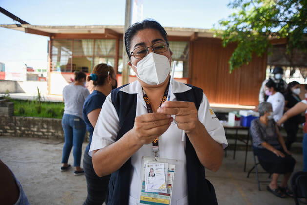 March 30, 2021, Tuzamapan, Veracruz, Mo xico: The musical group Los super Caracoles plays their songs while older adults wait in line to be vaccinated against Covid-19. Some older adults joined the dance and celebration to receive the vaccine Tuzamapan MÃ xico - ZUMAqp1_ 20210330_zip_qp1_004 Copyright: xHectorxAdolfoxQuintanarxPerezx