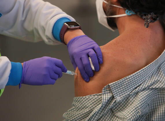 A man is vaccinated against Covid-19 in a device installed at the Wanda Metropolitano Stadium in Madrid, Spain, on March 30, 2021. The Community of Madrid has begun to vaccinate this Tuesday against Covid-19 to the general population aged 60 to 65 years with doses of AstraZeneca. Also, next week will begin to vaccinate people aged 77, 78 and 79 years with doses of Pfizer. 30 MARCH 2021;WANDA METROPOLITANO;MADRID;COMMUNITY OF MADRID Marta Fernandez Jara LagenciaEP 03 30 2021 MADRID MADRID Spain Copyright: xMartaxFernandezxJarax 3627696