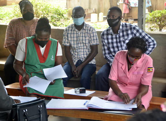 (210331) -- KAMPALA, March 31, 2021 -- Teachers attend COVID-19 vaccination campaign at a health center in Kampala, capital of Uganda, March 31, 2021. Uganda launched the first phase of COVID-19 vaccination campaign on March 10, targeting high risk groups in the east African country. The ministry of health targets to vaccinate more than 21.9 million people who face the highest risk of the infection, which include health workers, teachers, security personnel, elderly and those with underlying medical conditions. (Photo by Xinhua) UGANDA-KAMPALA-TEACHERS-VACCINATION NicholasxKajoba