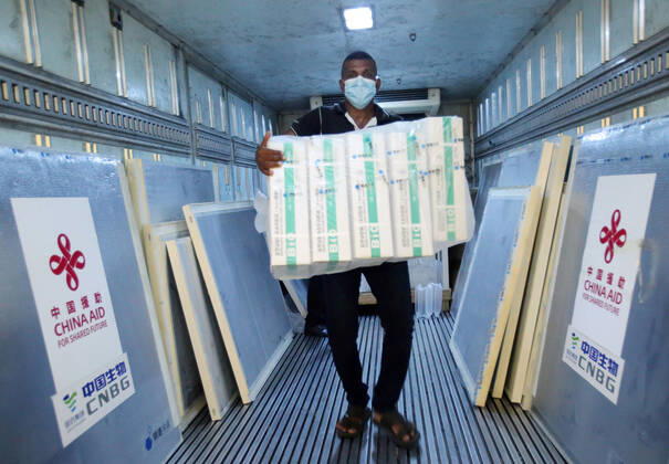 (210401) -- COLOMBO, April 1, 2021 -- A worker unloads Sinopharm COVID-19 vaccines at the Bandaranaike International Airport in Colombo, Sri Lanka, March 31, 2021. A batch of Sinopharm vaccines arrived in Sri Lanka from China on Wednesday as part of a donation by the Chinese government to the island nation. (Photo by Xinhua) SRI LANKA-COLOMBO-CHINA-COVID-19-VACCINES-ARRIVAL AjithxPerera 
