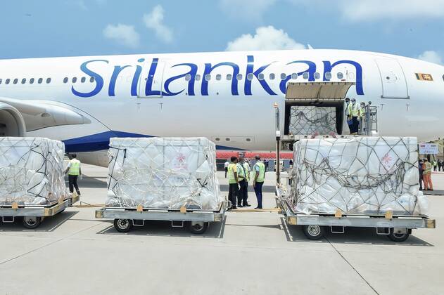 (210401) -- COLOMBO, April 1, 2021 -- Workers transport Sinopharm COVID-19 vaccines at the Bandaranaike International Airport in Colombo, Sri Lanka, March 31, 2021. A batch of Sinopharm vaccines arrived in Sri Lanka from China on Wednesday as part of a donation by the Chinese government to the island nation. ( Handout via Xinhua) SRI LANKA-COLOMBO-CHINA-COVID-19-VACCINES-ARRIVAL SrixLankanxPresidentxMediaxDivision 
