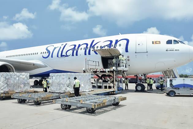 (210401) -- COLOMBO, April 1, 2021 -- Workers transport Sinopharm COVID-19 vaccines at the Bandaranaike International Airport in Colombo, Sri Lanka, March 31, 2021. A batch of Sinopharm vaccines arrived in Sri Lanka from China on Wednesday as part of a donation by the Chinese government to the island nation. ( Handout via Xinhua) SRI LANKA-COLOMBO-CHINA-COVID-19-VACCINES-ARRIVAL SrixLankanxPresidentxMediaxDivision 