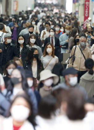 Scene of Osaka amid coronavirus pandemic People wearing face masks walk in Osaka s Minami area on April 2, 2021, amid a resurgence in coronavirus infections in the western Japan prefecture. 