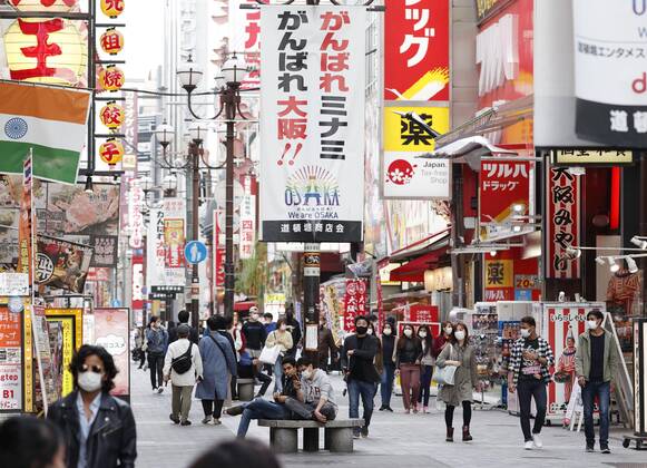 Scene of Osaka amid coronavirus pandemic People wearing face masks walk in Osaka s Minami area on April 2, 2021, amid a resurgence in coronavirus infections in the western Japan prefecture. 