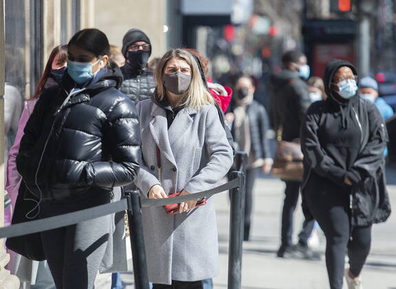 April 2, 2021, Montreal, PQ, Canada: People wear face masks as they wait to enter a store in Montreal, Friday, April 2, 2021, as the COVID-19 pandemic continues in Canada and around the world. Montreal Canada - ZUMAc35_ 20210402_zaf_c35_001 Copyright: xGrahamxHughesx