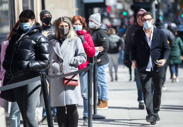 April 2, 2021, Montreal, PQ, Canada: People wear face masks as they wait to enter a store in Montreal, Friday, April 2, 2021, as the COVID-19 pandemic continues in Canada and around the world. Montreal Canada - ZUMAc35_ 20210402_zaf_c35_003 Copyright: xGrahamxHughesx