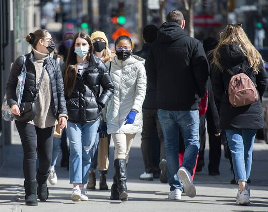 April 2, 2021, Montreal, PQ, Canada: People wear face masks as they walk along a street in Montreal, Friday, April 2, 2021, as the COVID-19 pandemic continues in Canada and around the world. Montreal Canada - ZUMAc35_ 20210402_zaf_c35_005 Copyright: xGrahamxHughesx