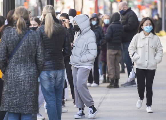 April 2, 2021, Montreal, PQ, Canada: People wear face masks as they wait to enter a store in Montreal, Friday, April 2, 2021, as the COVID-19 pandemic continues in Canada and around the world. Montreal Canada - ZUMAc35_ 20210402_zaf_c35_008 Copyright: xGrahamxHughesx