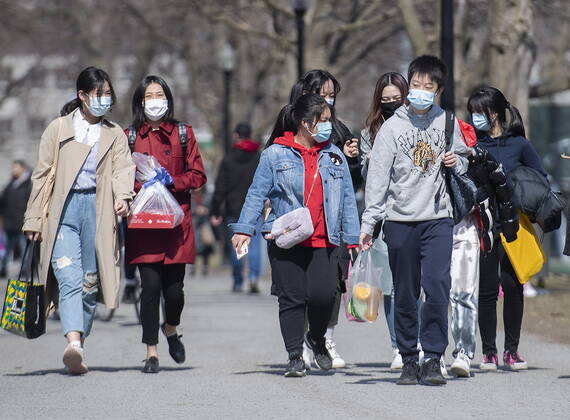 April 4, 2021, Montreal, PQ, Canada: People wear face masks as they walk in a park in Montreal, Sunday, April 4, 2021, as the COVID-19 pandemic continues in Canada and around the world. Montreal Canada - ZUMAc35_ 20210404_zaf_c35_061 Copyright: xGrahamxHughesx