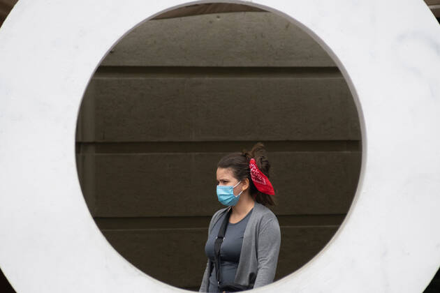 April 4, 2021, Santiago, Metropolitana, Chile: A woman with a mask is seen in the middle of a sign that says STGO, in the middle of the total quarantine decreed last week for the Metropolitan Region, due to the second wave of coronavirus that is collapsing the health system. Santiago Chile - ZUMAb332 20210404_zip_b332_009 Copyright: xMatiasxBasualdox