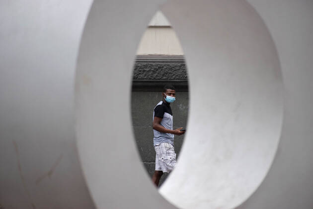 April 4, 2021, Santiago, Metropolitana, Chile: A man with a mask passes a giant sign that says STGO, in the middle of the total quarantine decreed last week for the Metropolitan Region. Santiago Chile - ZUMAb332 20210404_zip_b332_013 Copyright: xMatiasxBasualdox