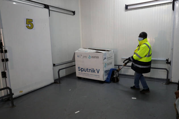 (210404) -- TRIPOLI, April 4, 2021 -- A worker transfers COVID-19 vaccines in Tripoli, Libya, on April 4, 2021. The Libyan Minister of Health Ali Zanati on Sunday announced that a shipment of 101,250 doses of Russia s Sputnik V COVID-19 vaccine, provided by the United Arab Emirates, arrived in Tripoli. (Photo by Xinhua) LIBYA-TRIPOLI-COVID-19 VACCINE-ARRIVAL HamzaxTurkia