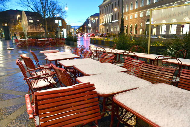 Themenbild: Coronavirus Pandemie Folgen fuer die Gastronomie-kommt nun der Bruecken Lockdown? Schneebedckte und zusammengebundene leere Tische und Stuehle vor einem Restaurant,Aussengastronomie in der Brienner Strasse in Muenchen am 06.04.2021 nach Wintereinbruch.