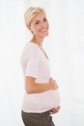 Portrait of smiling blonde pregnant Portrait of smiling blonde pregnant with white background, model released, Cape Town, South Africa, 03.02.2015, 533246.jpg, home, house, household, homey, apartment, domicile, abode, lifestyle, leisure, domestic life, casual clothing, pregnancy, expecting, pregnant, belly, maternity, holding, touching, anticipation, calm, peaceful, relaxing, content, happy, smiling, cheerful, fair hair, blonde, light hair, short hair 20s, Young Adult, Woman, Female, Caucasian, 20-24 Years, Young Women, Caucasian Ethnicity Indoors,Day