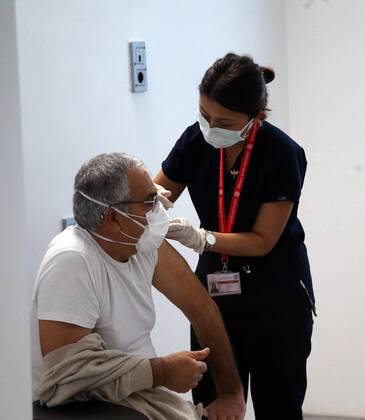 (210407) -- ANKARA, April 7, 2021 -- A man receives the COVID-19 vaccine in Ankara, Turkey, April 7, 2021. Turkey on Wednesday reported its largest single-day increase in infections with 54,740 new COVID-19 cases, according to its health ministry. (Photo by Xinhua) TURKEY-ANKARA-COVID-19 CASES-SURGE MustafaxKaya