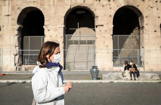 (210408) -- ROME, April 8, 2021 -- A woman wearing a face mask walks past the Colosseum in Rome, Italy, on April 8, 2021. Italy on Thursday reported 17,221 new coronavirus cases, bringing the number of active infections to 544,330, according to the latest data from the Ministry of Health. ) ITALY-ROME-COVID-19-CASES ChengxTingting