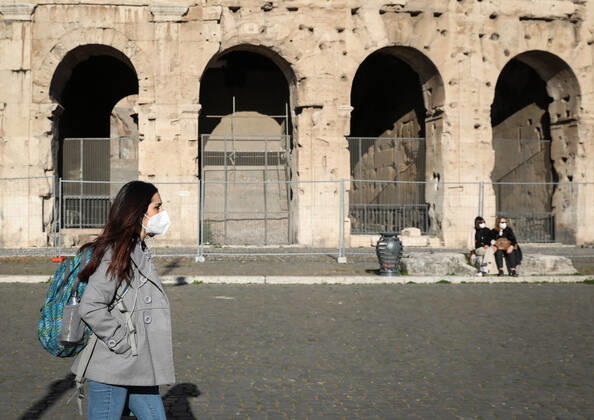 (210408) -- ROME, April 8, 2021 -- A woman wearing a face mask walks past the Colosseum in Rome, Italy, on April 8, 2021. Italy on Thursday reported 17,221 new coronavirus cases, bringing the number of active infections to 544,330, according to the latest data from the Ministry of Health. ) ITALY-ROME-COVID-19-CASES ChengxTingting