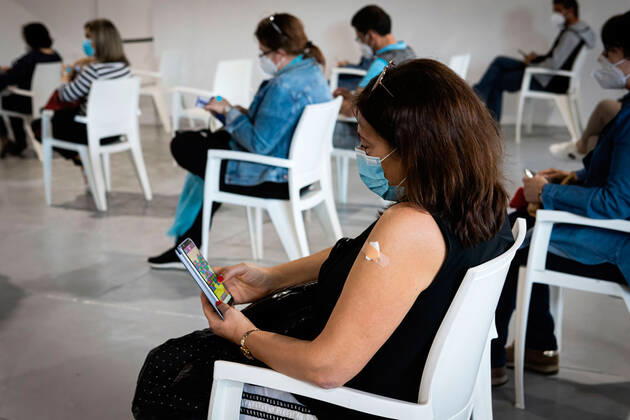 April 17, 2021, Matosinhos, Porto, Portugal: A woman wearing a facemask as a preventive measure against the spread of covid-19 waits in the recovery room with the plaster covering the vaccine spot..The nationwide mass vaccination of teachers and school staff started on 17th April in the Matosinhos Vaccination Centre, 1952 people were vaccinated on the first Saturday with Cominarty vaccine produced by Pfizer. Matosinhos Portugal - ZUMAs197 20210417_zaa_s197_271 Copyright: xTeresaxNunesx