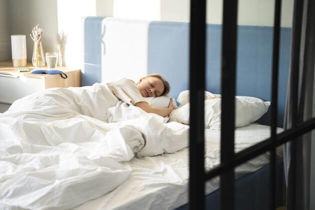 Woman sleeping in bed at home model released Symbolfoto property released VPIF03730