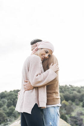 Smiling girlfriend embracing boyfriend model released Symbolfoto DAMF00755