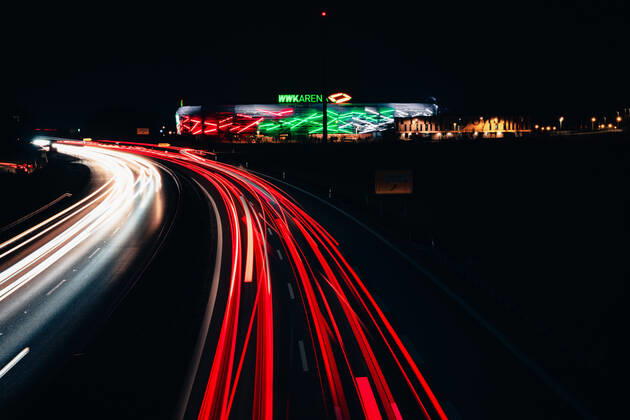 Augsburg, Bavaria, Germany - 25 march 2021: WWK soccer stadium of the Fca at night. traces of light from passing cars at night. the wwk arena is illuminated.